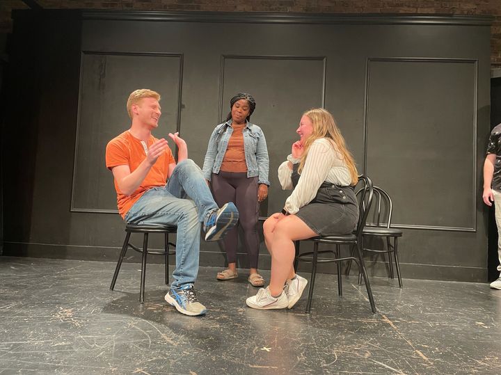 Three improvisers on stage at The Annoyance theatre