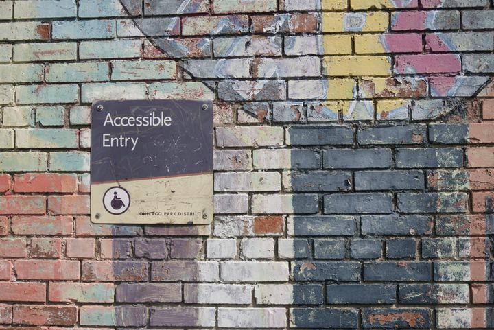 A painted brick wall features a Chicago Park District sign that reads, "Accessible Entry."